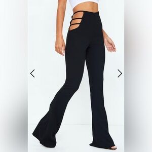 Black flared pants, with a cut out detail at the top.